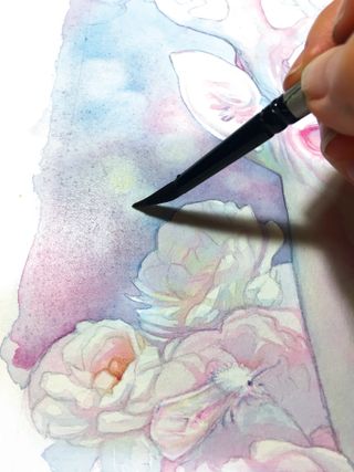 A brush removing an area of watercolour paint