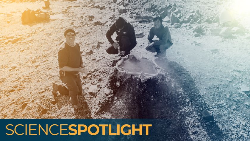 A photo of three men crouched around a hole in the ground emitting helium gas