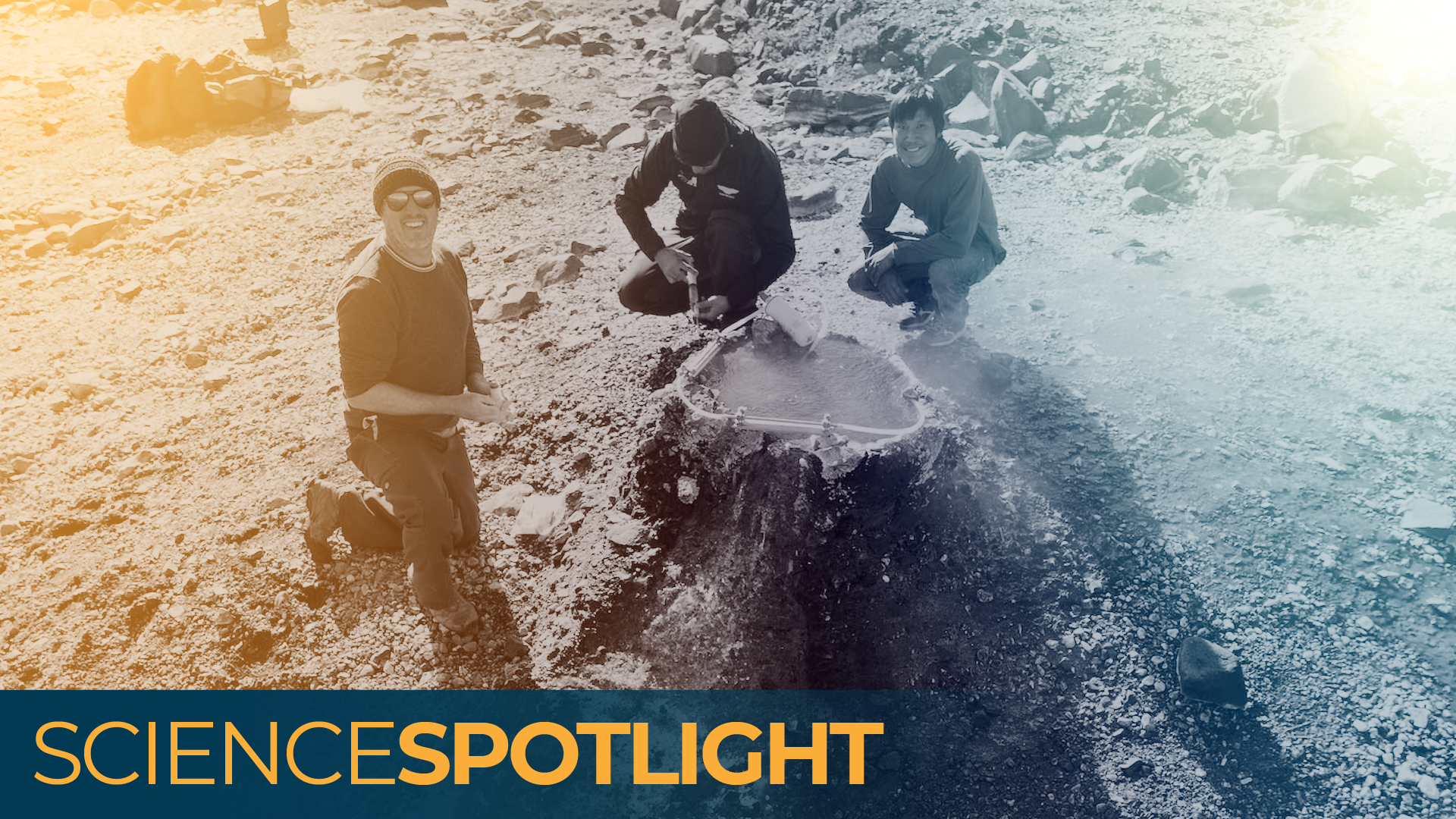 A photo of three men crouched around a hole in the ground emitting helium gas