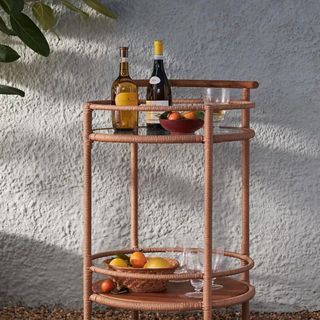 Percy Outdoor Bar Cart against a white wall.