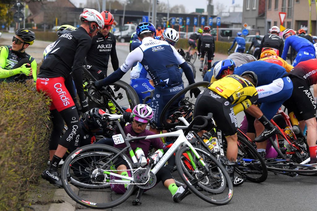 NOKERE BELGIUM MARCH 17 The peloton during the 75th Nokere Koerse Danilith Classic 2021 Mens Elite a 1955km race from Deinze to Nokere Crash Injury NokereKoerse on March 17 2021 in Nokere Belgium Photo by Luc ClaessenGetty Images