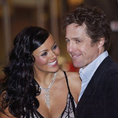 Hugh Grant (R) and Martine McCutcheon arrive for the UK premiere of the film "Love Actually", at the Odeon Cinema, Leicester Square in London, 16 November 2003. "Love Actually" is the latest film from director Richard Curtis, who made "Four Weddings and a Funeral" and "Notting Hill".