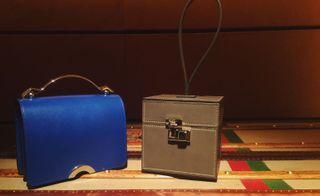 Blue handbag and a brown small trunk