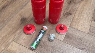 Energy tablets and water bottles on wooden floor