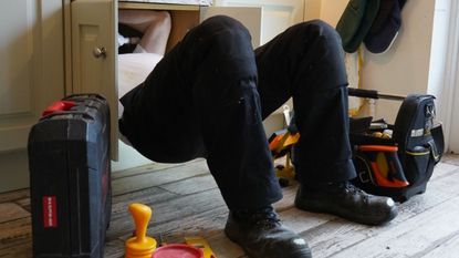 Plumber under a sink