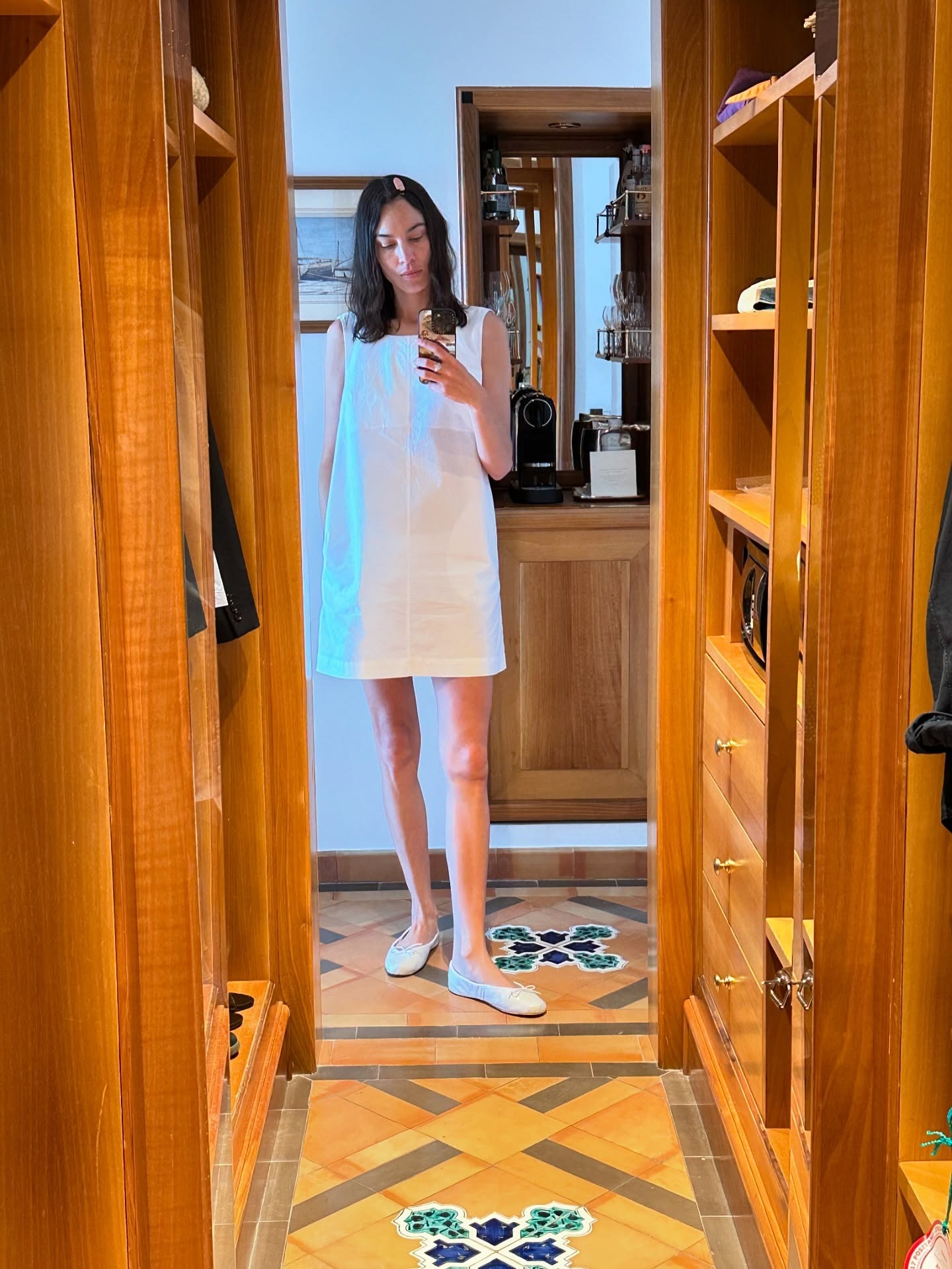 Alexa Chung styled her white minidress with white ballet flats on holiday in Positano.