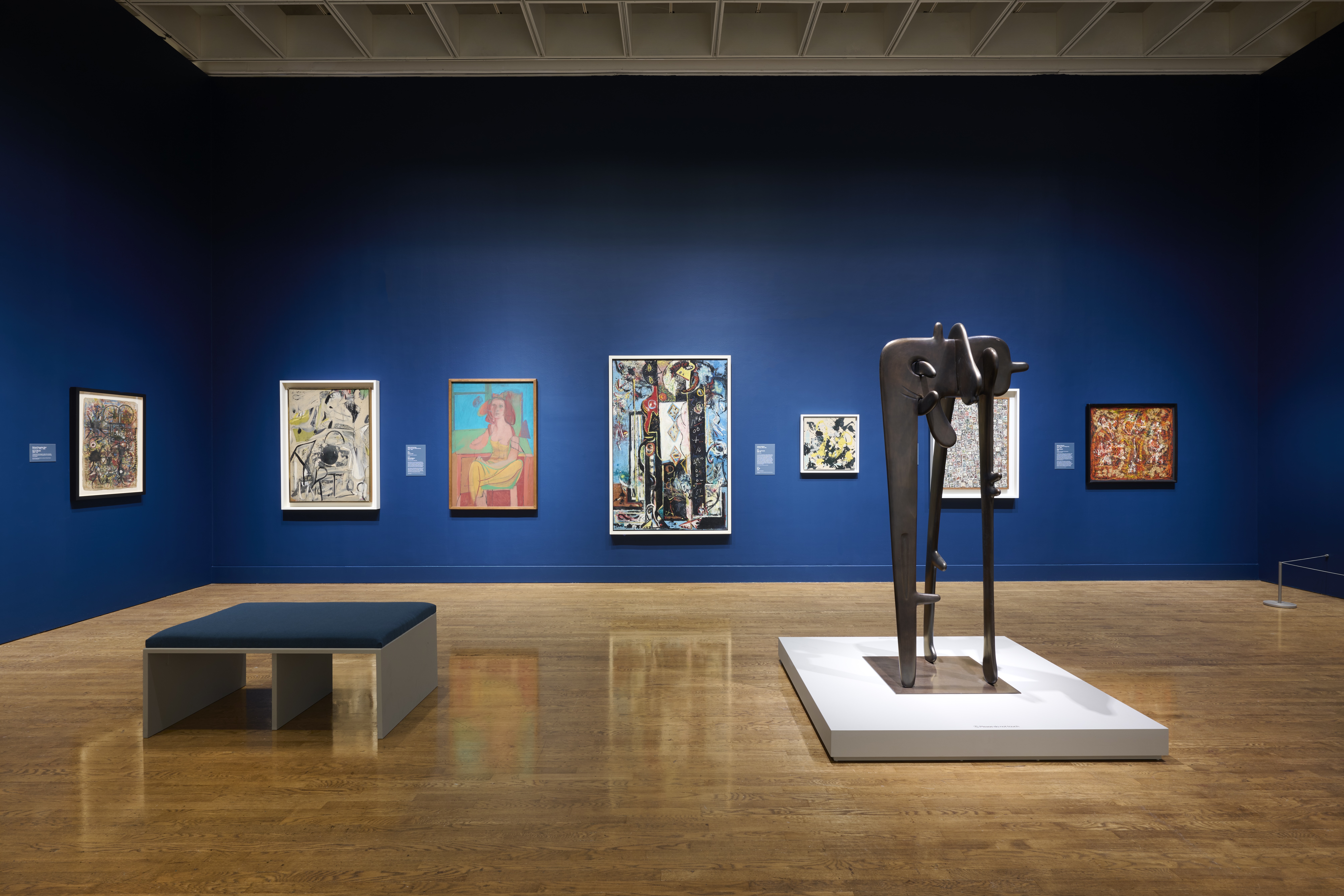 bronze sculpture in blue exhibition space