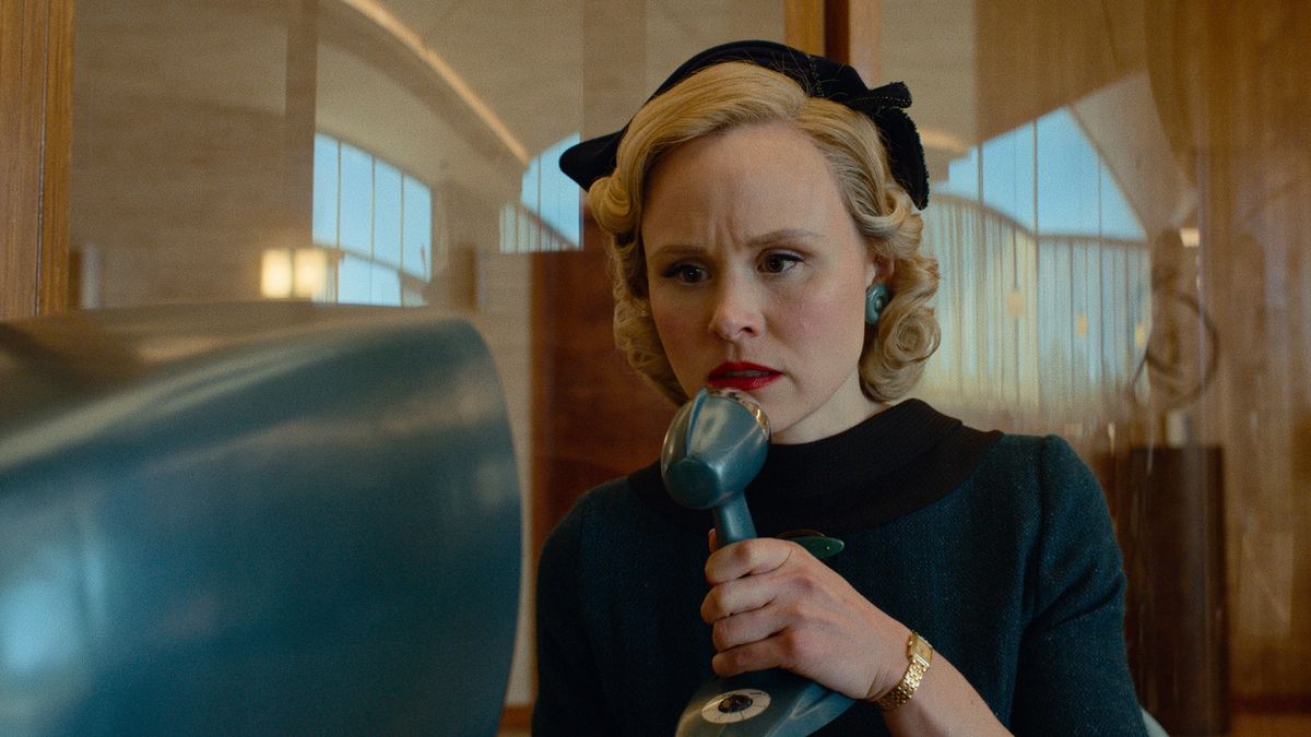 Alison Pill speaking into a microphone in Hello Tomorrow!