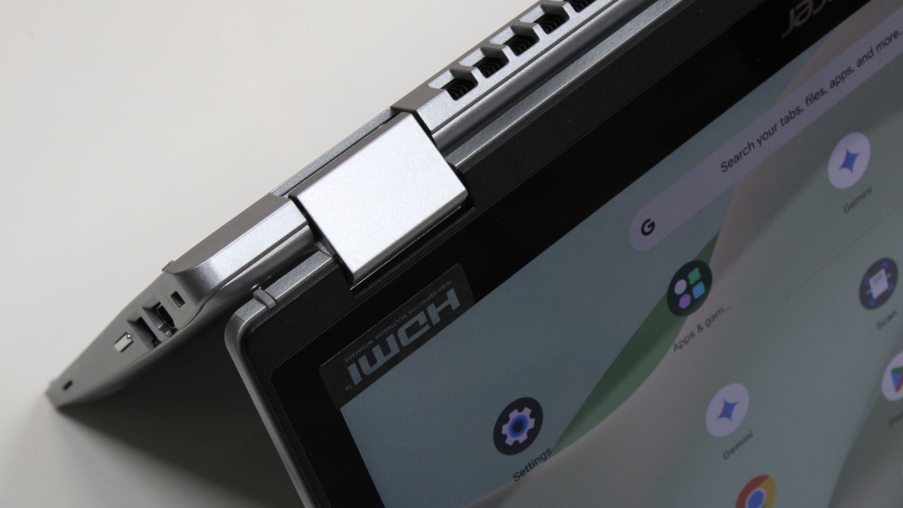 A close up of a silver, rectangular laptop display hinge