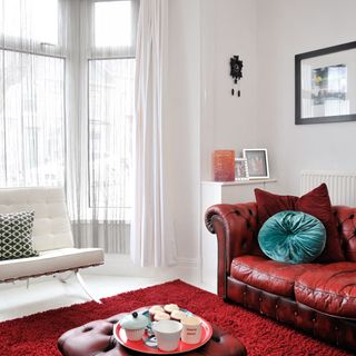 living room with white wall and curtains on window