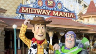 Buzz and Woody walk around characters in front of Midway Mania