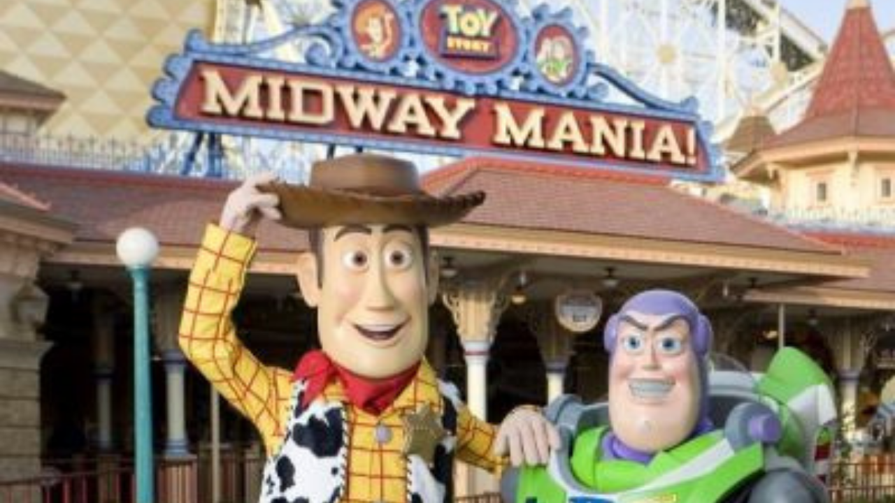 Buzz and Woody walk around characters in front of Midway Mania