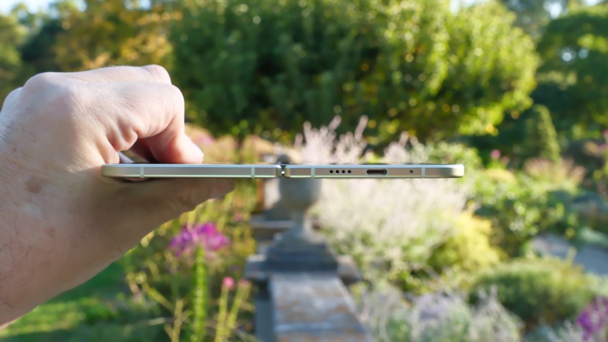 Google Pixel 10 Pro Fold in Jade green outside at a flower garden on a sunny day