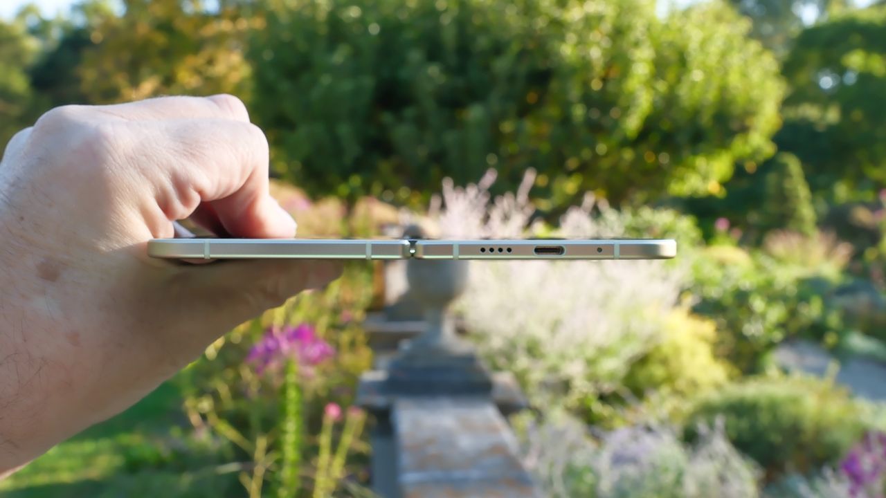 Google Pixel 10 Pro Fold in Jade green outside at a flower garden on a sunny day