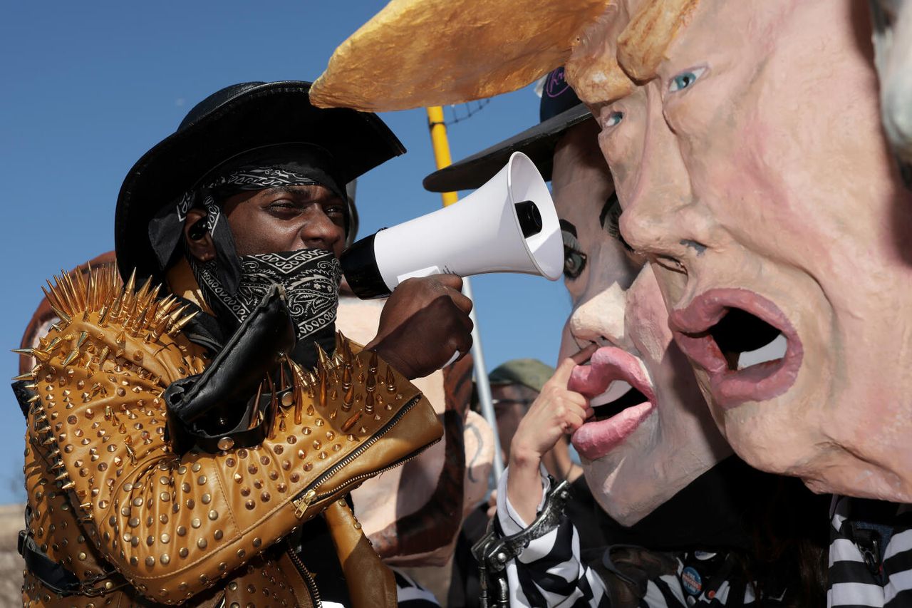 WASHINGTON, DC - FEBRUARY 28: Protesters demonstrate against President Trump and his administration during the &amp;quot;March 4 Democracy&amp;quot; rally on the National Mall on February 28, 2026 in Washington, DC. The protest was already scheduled before President Donald Trump announced that the United States and Israel had launched an attack on Iran Saturday morning. (Photo by Heather Diehl/Getty Images)