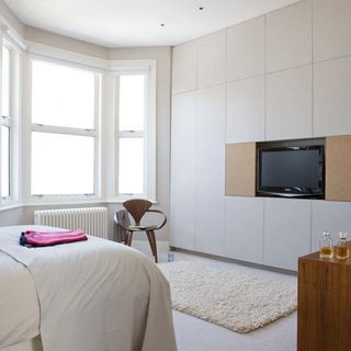 bedroom with white wall and television