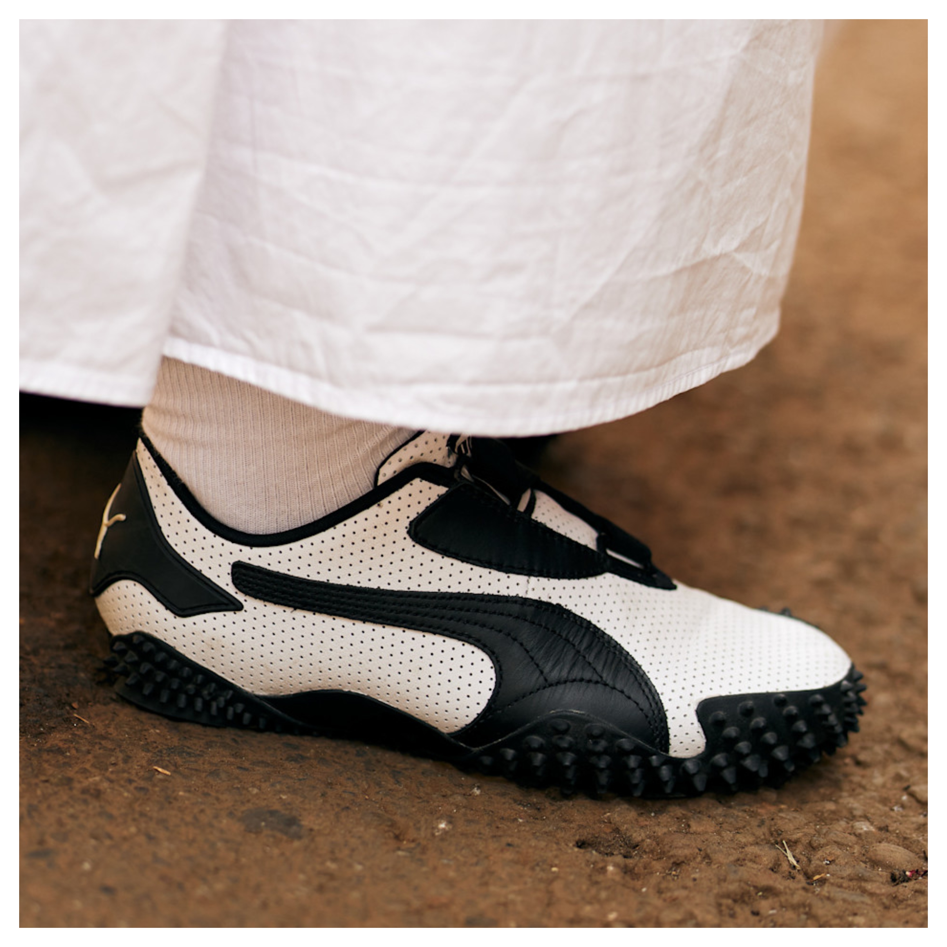 woman wearing white dress and white puma sneakers