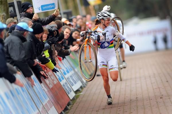 Marianne Vos runs her bike to the line after rolling her tire