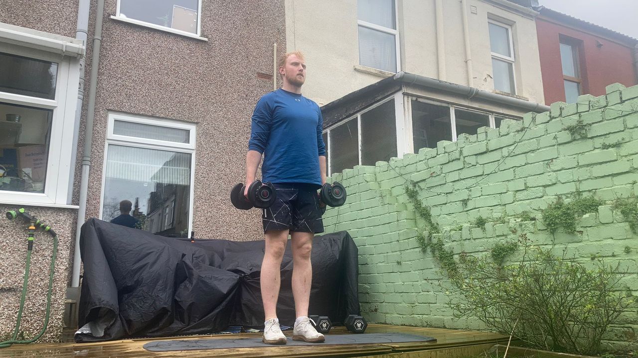 Fit&amp;Well fitness writer Harry Bullmore demonstrating a hammer curl to lateral raise