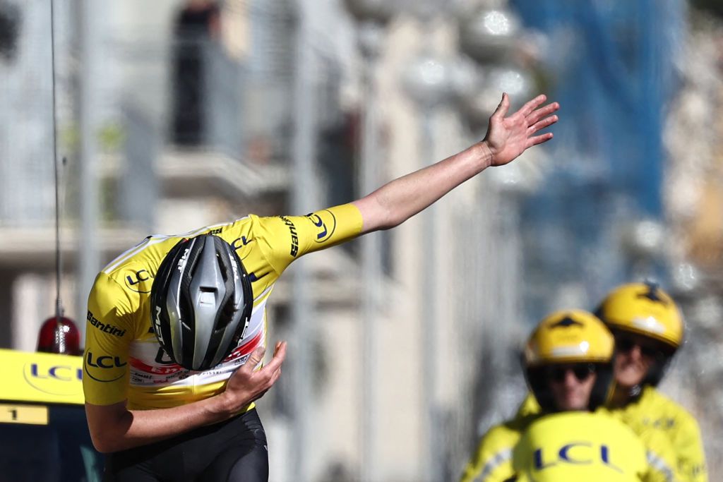 TOPSHOT UAE Team Emirates Slovenian rider Tadej Pogacar C wearing the overall leaders yellow jersey celebrates as he crosses the finish line of the 8th and final stage of the 81st Paris Nice cycling race 1175 km between Nice and Nice on the Promenade des Anglais of the French riviera city of Nice southeastern France on March 12 2023 Tadej Pogacar won a third stage of the ParisNice race on March 12 2023 to take a crushing overall victory in his first entry to the prestigious eightday event Photo by AnneChristine POUJOULAT AFP Photo by ANNECHRISTINE POUJOULATAFP via Getty Images