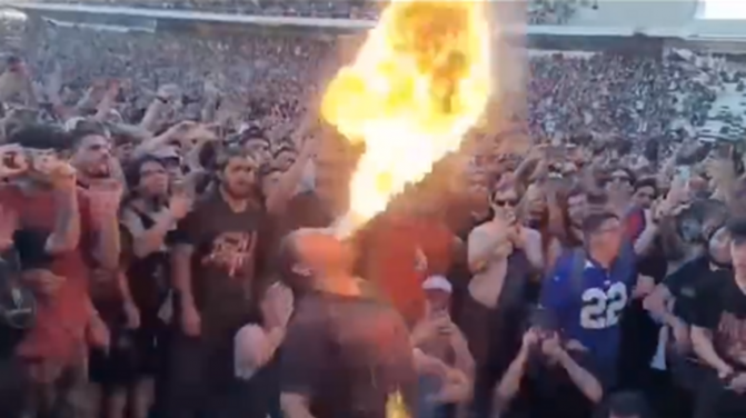 Pantera fan breathing fire in mosh pit