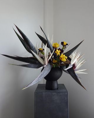 a fresh flower arrangement on a gray pedestal