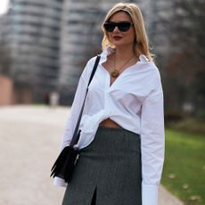 milan fashion week attendee wearing white blouse and black sunglasses