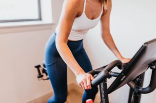 A woman on an exercise bike