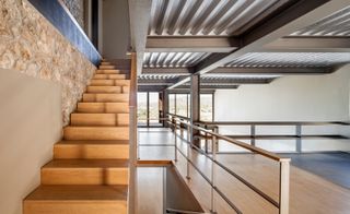 Oak flooring and stair treads seek to soften the design