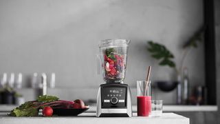 An image of the Vitamix Ascent A3500 Blender making a smoothie with red fruit