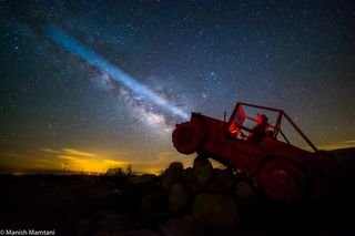 The headlights of a Jeep appear to shine across the Milky Way in this stunning photo by photographer Manish Mamtani at Borrego Springs, California on April 17-19, 2015.