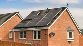 detached brick house with solar panels on roof