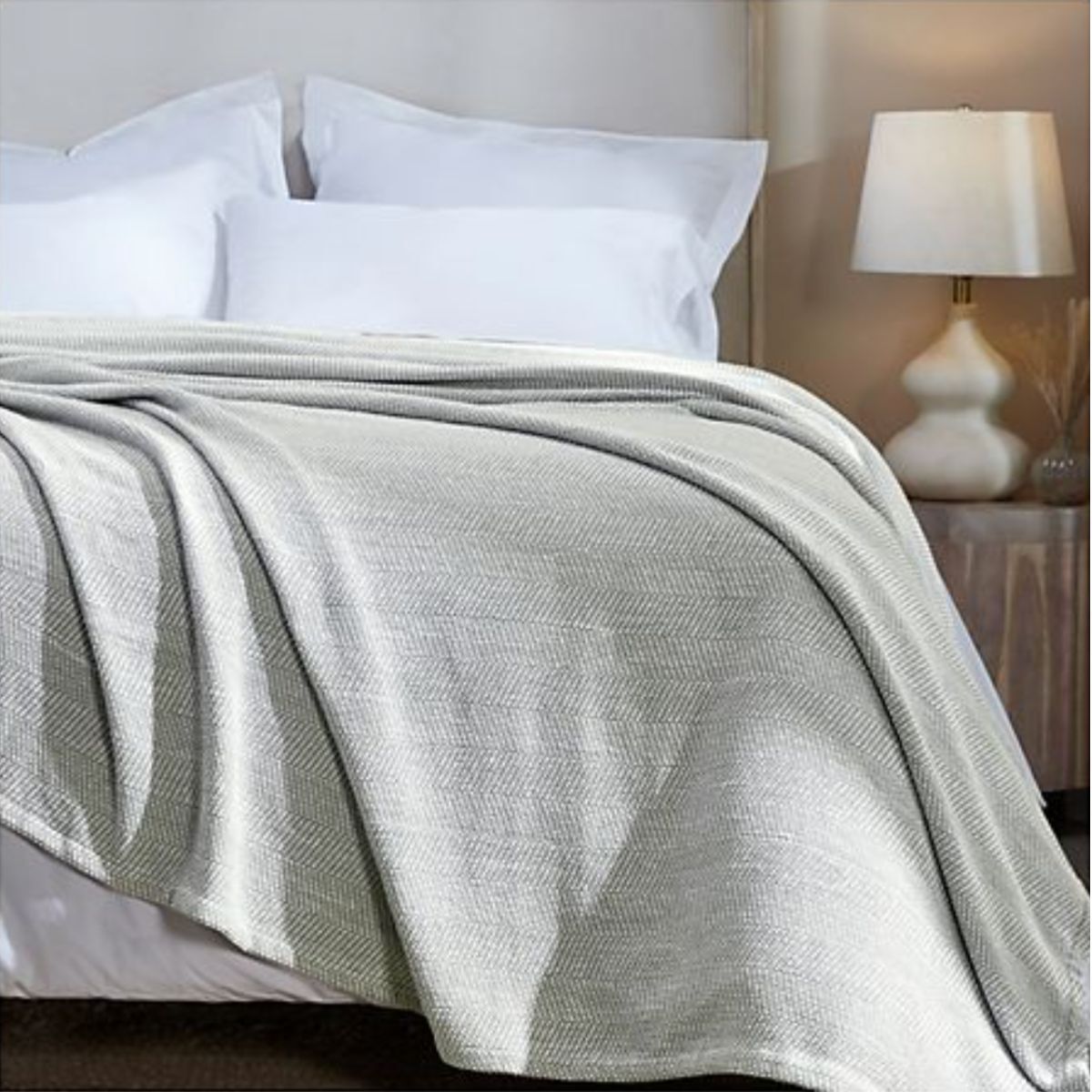 A bed with a herringbone throw