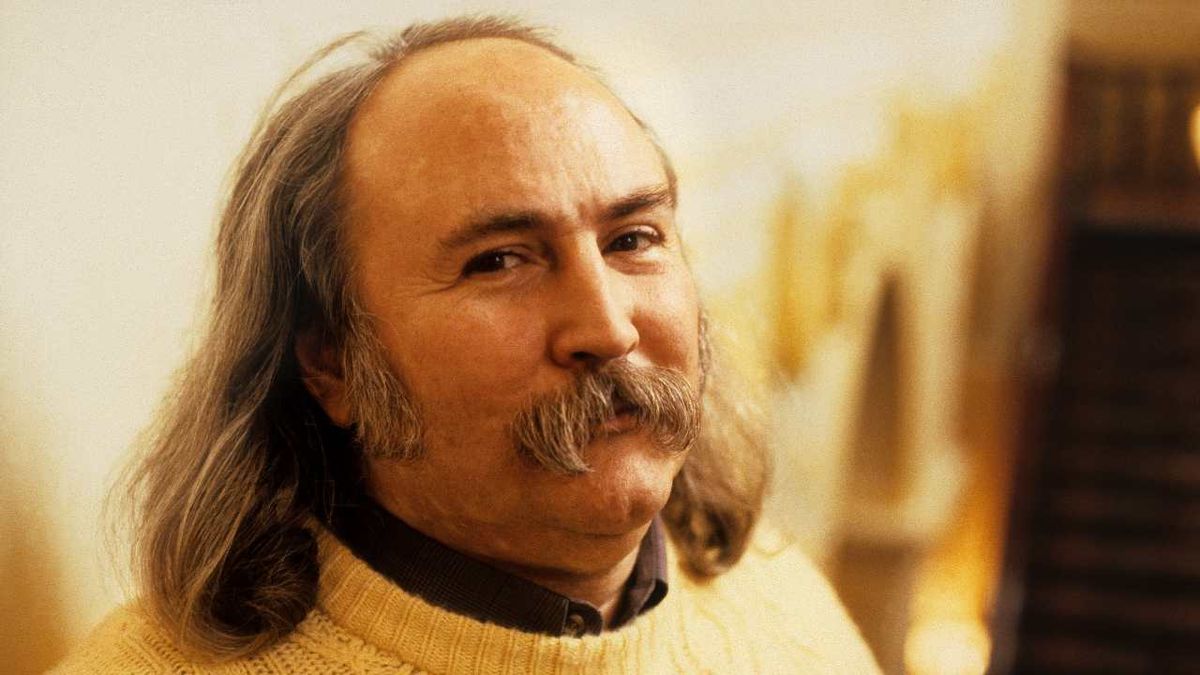 David Crosby wearing a white knitted jumper