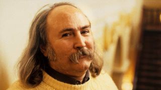 David Crosby wearing a white knitted jumper