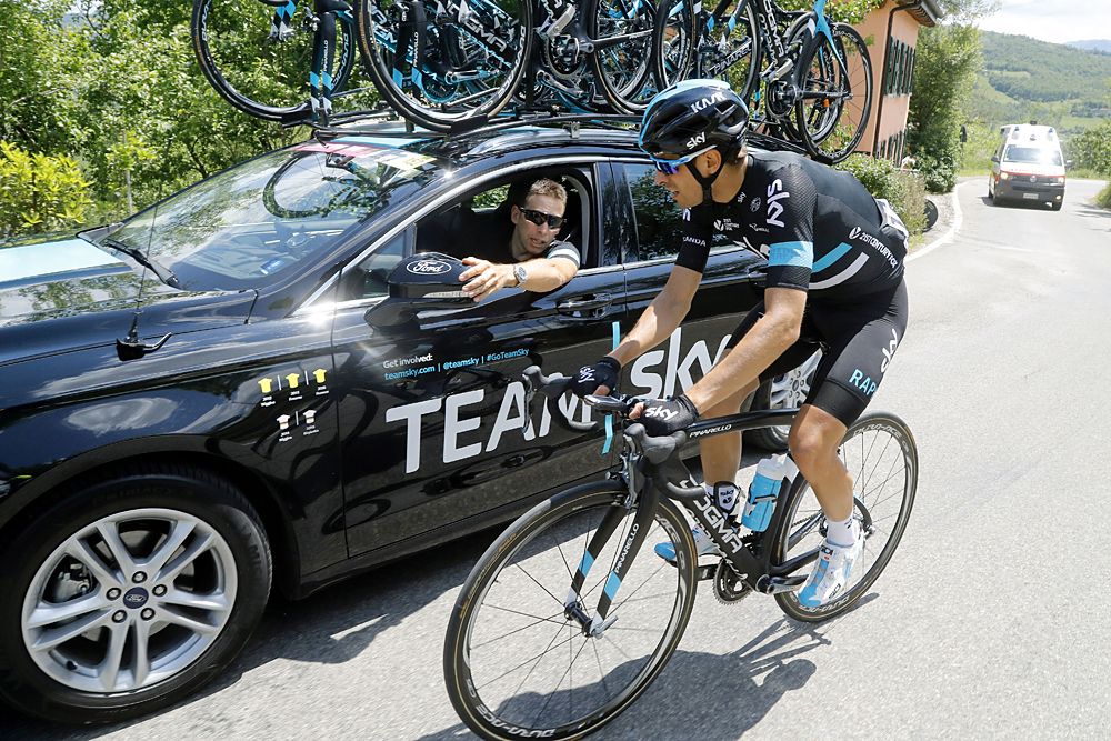 Spanish cyclist Mikel Landa speaks with his sport director Italian Dario David Ciono prior to abandon during the 10th stage of the 99th Giro d'Italia