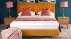 bed with orange headboard and frame