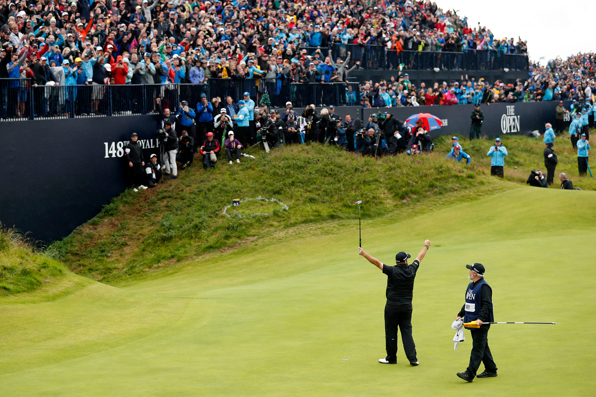 Shane Lowry celebrating in front of the grandstands after winning the 2019 Open Championship at Royal Portrush
