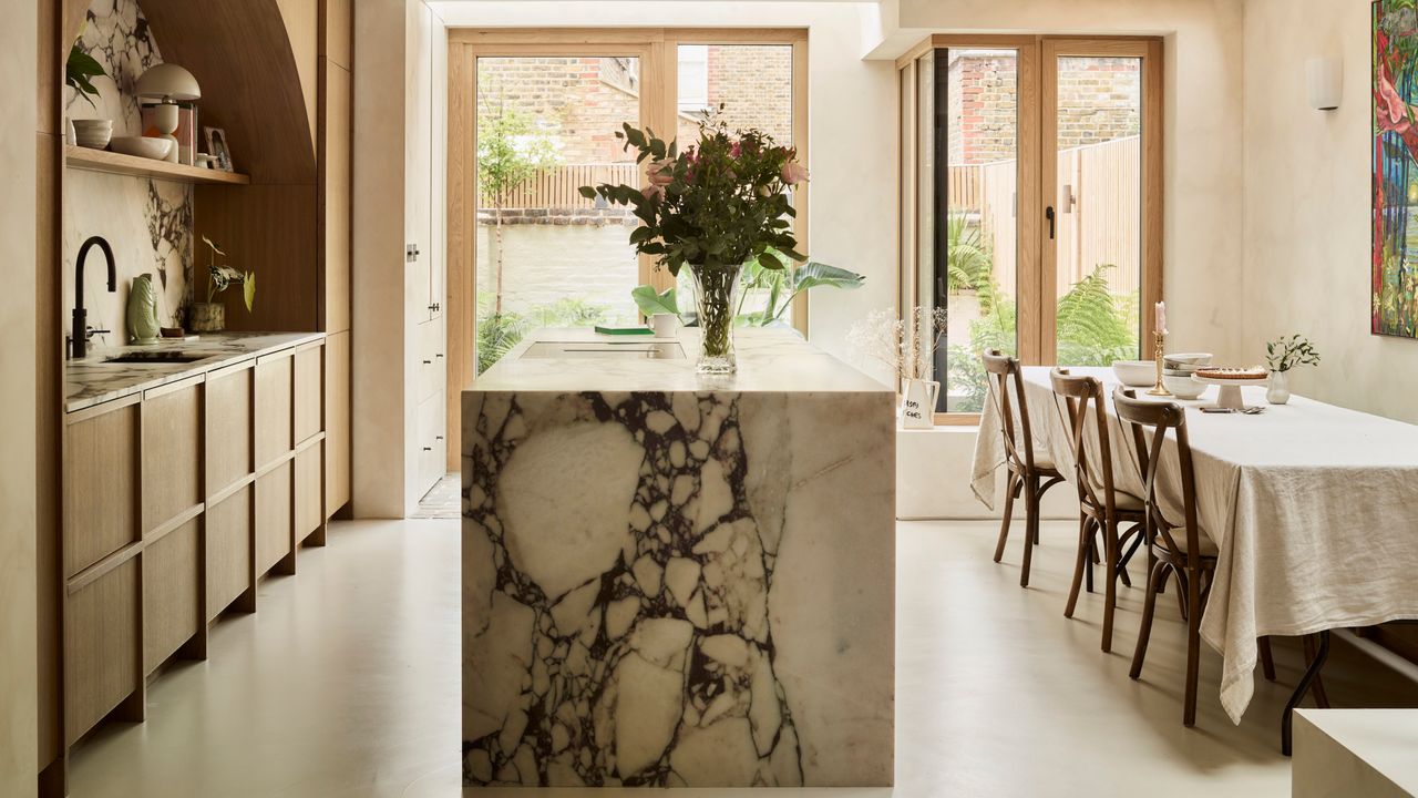 Kitchen-diner with marble island and timber cabinetry