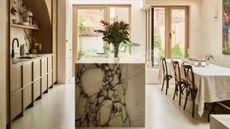 Kitchen-diner with marble island and timber cabinetry