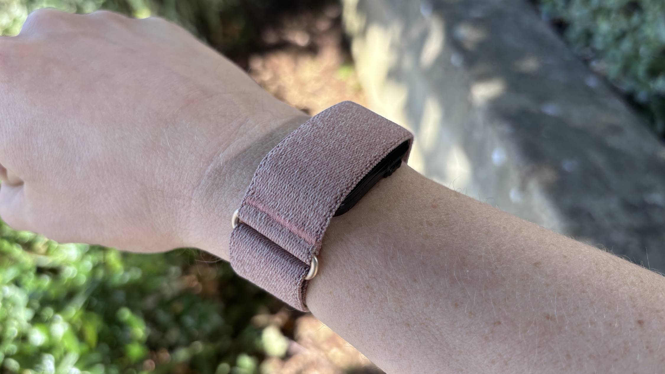 Garmin Cirqa worn on sunny day against stone background