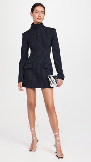 a model wears a navy blue pinstripe minidress 