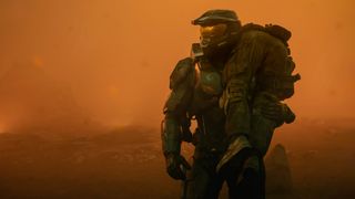 Master Chief (Pablo Schreiber) carrying a UNSC soldier over his shoulder in Halo season 2