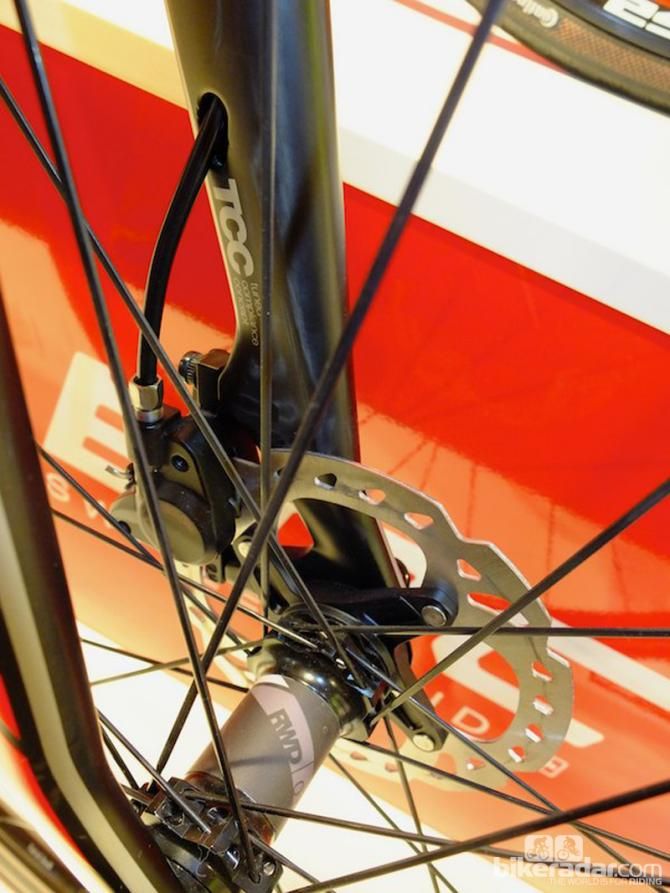 After passing through the headset top cap and steerer tube, the brake hose exits the left fork leg above the callipe