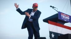 Donald Trump mimes golf swing at Florida rally