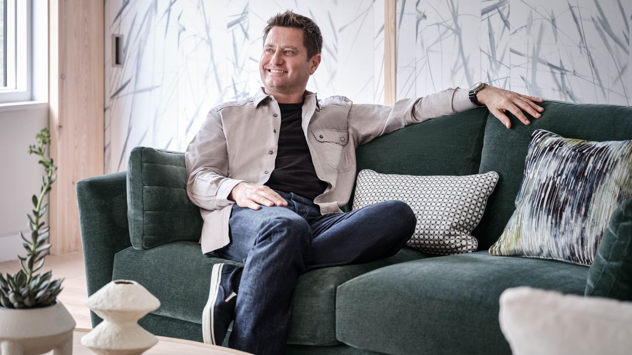 George Clarke sitting on Sofology&#039;s Sapporo 4 Seater in Manolo Slate Mix