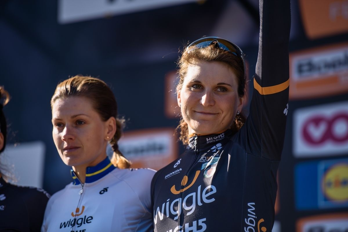 Elisa Longo Borghini waves from the podium
