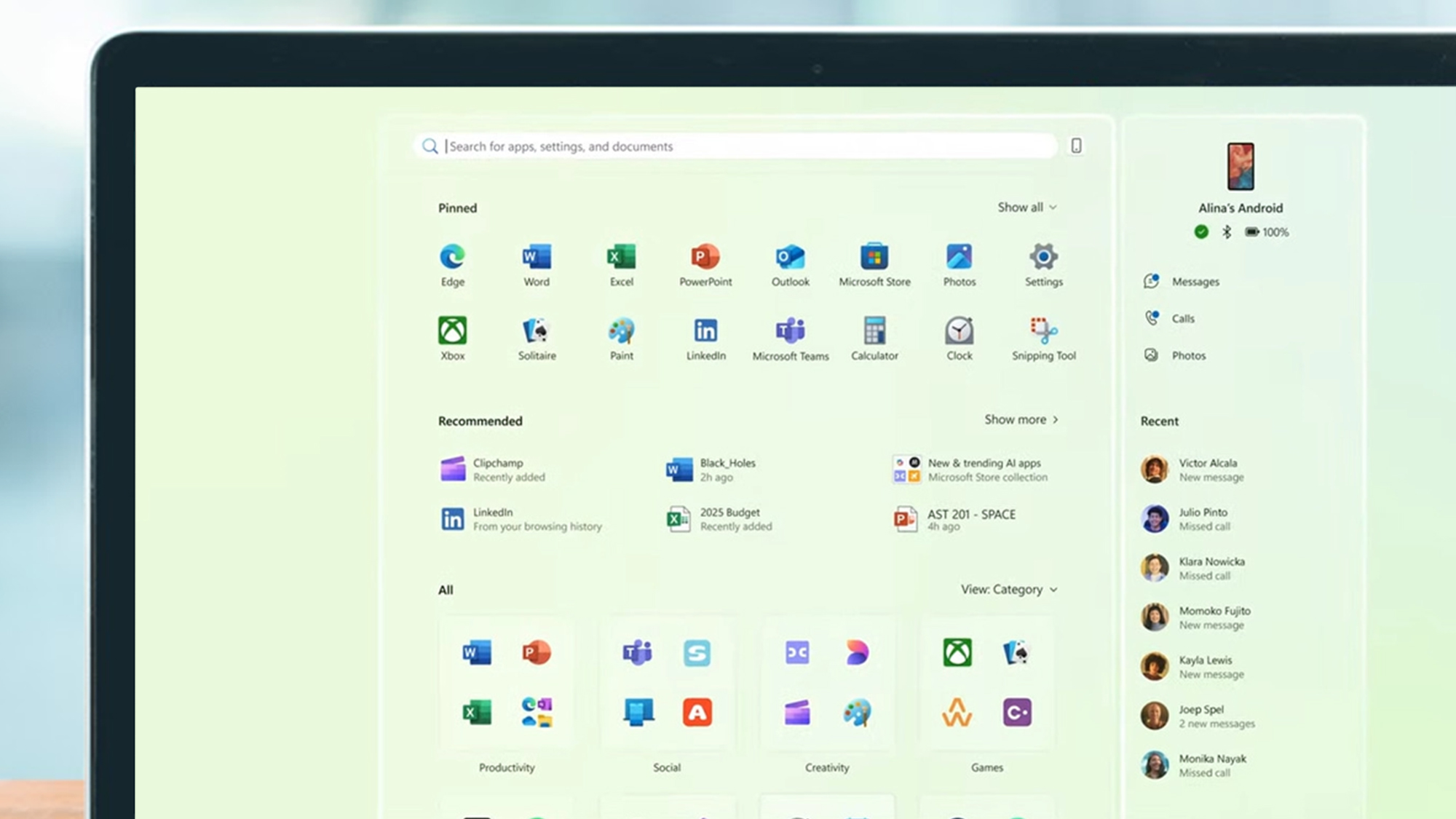 A laptop screen showing the Windows 11 Start Menu Redesign for 2025, with the new menu with Phone Link side panel to the right