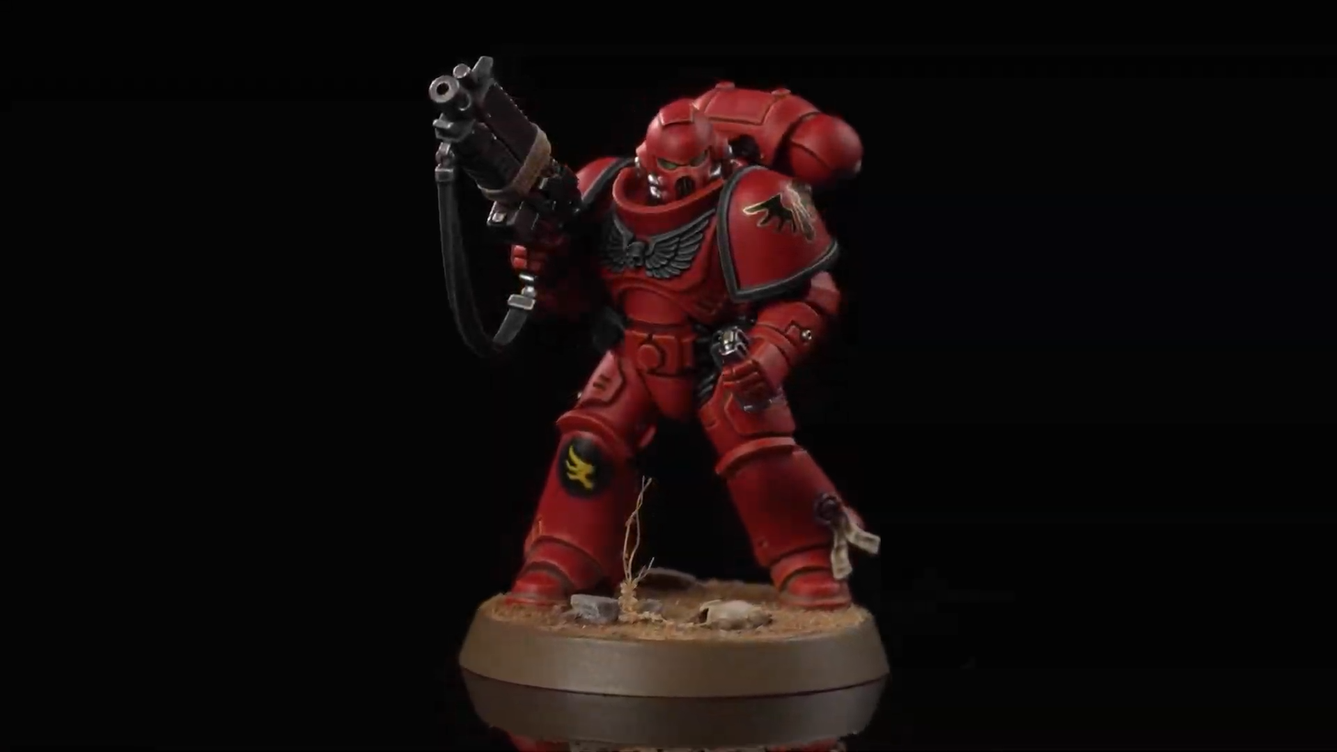 A Blood Angels Space Marine model against a black background