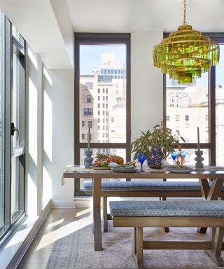 dining area with wooden table and benches, and green glass pendant